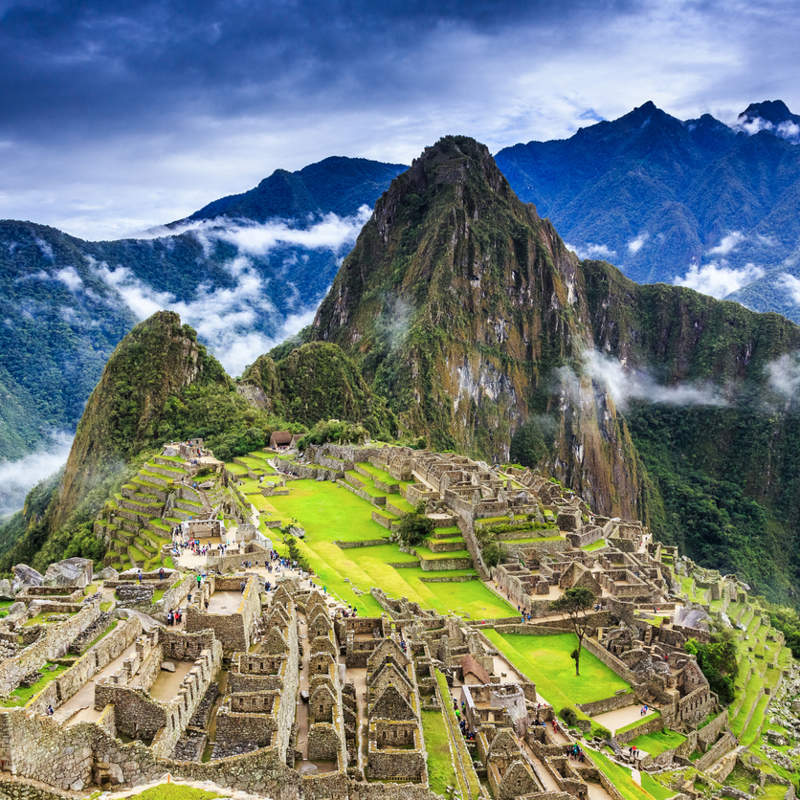 Vista panorámica de Machu Picchu entre montañas y nubes, uno de los destinos más emblemáticos para viajar por América del Sur